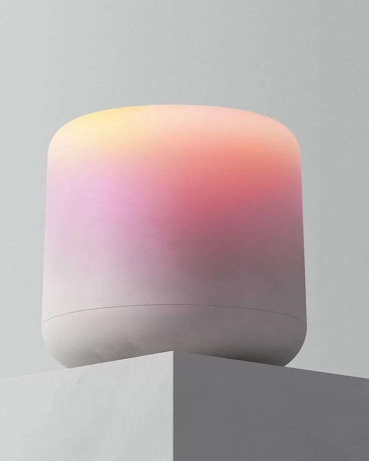 a white and pink object sitting on top of a pillar next to a
