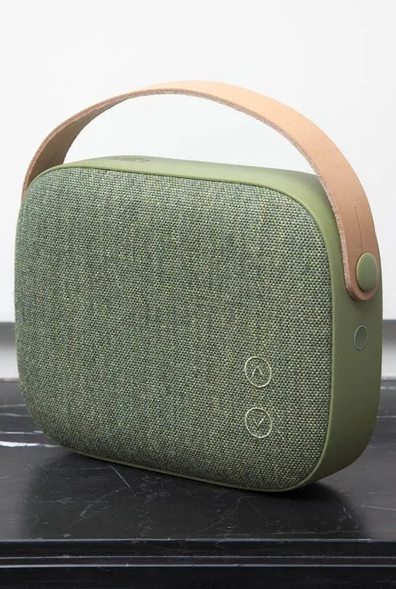a green and beige speaker sitting on top of a table