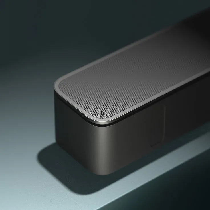 an electronic device sitting on top of a gray surface next t