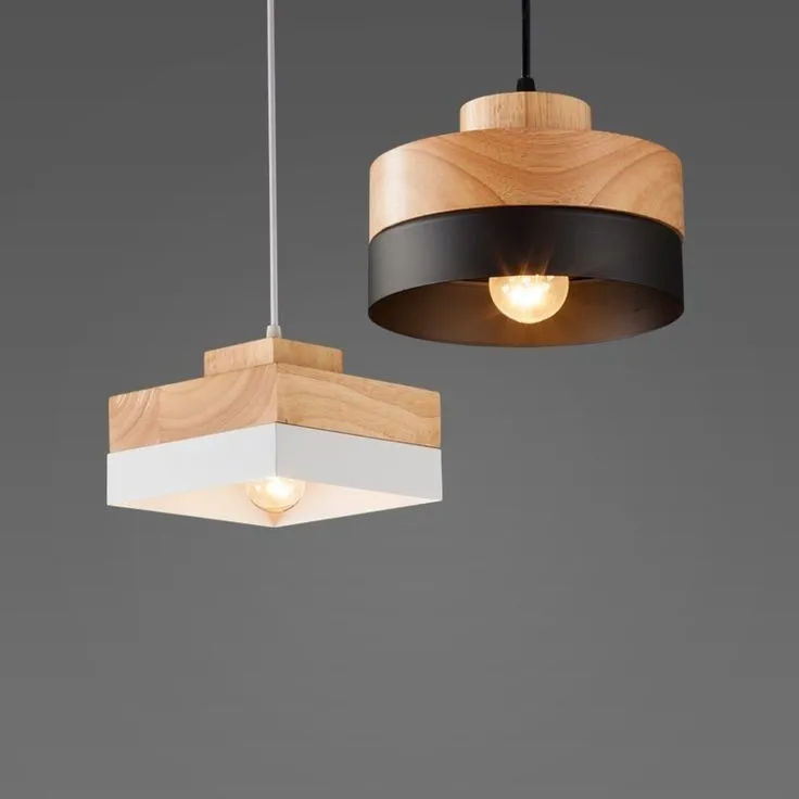 two wooden lights hanging from the ceiling in front of a gra